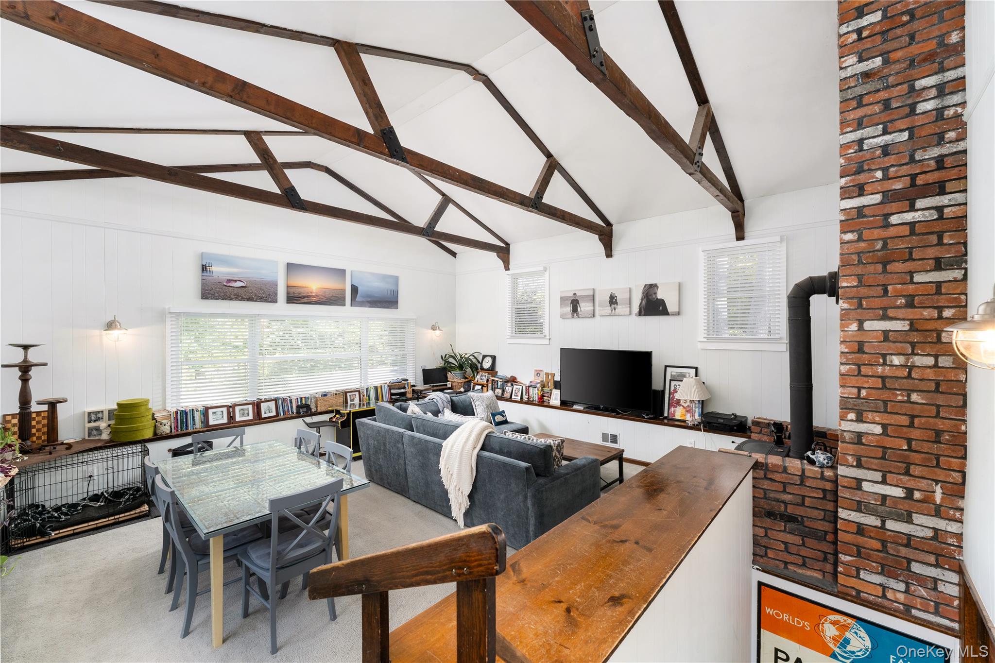 8 Foxboro Road Hampton Bays, NY 11946 - Photo 19 of 50 a living room with furniture a fireplace and a flat screen tv