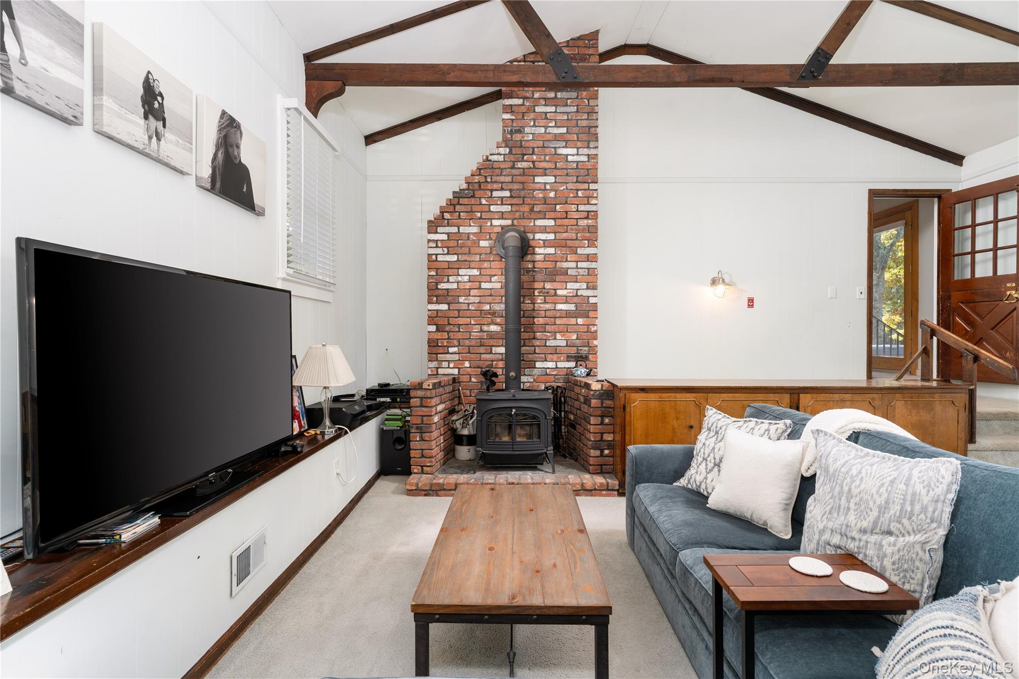 8 Foxboro Road Hampton Bays, NY 11946 - Photo 21 of 50 a living room with furniture and a flat screen tv