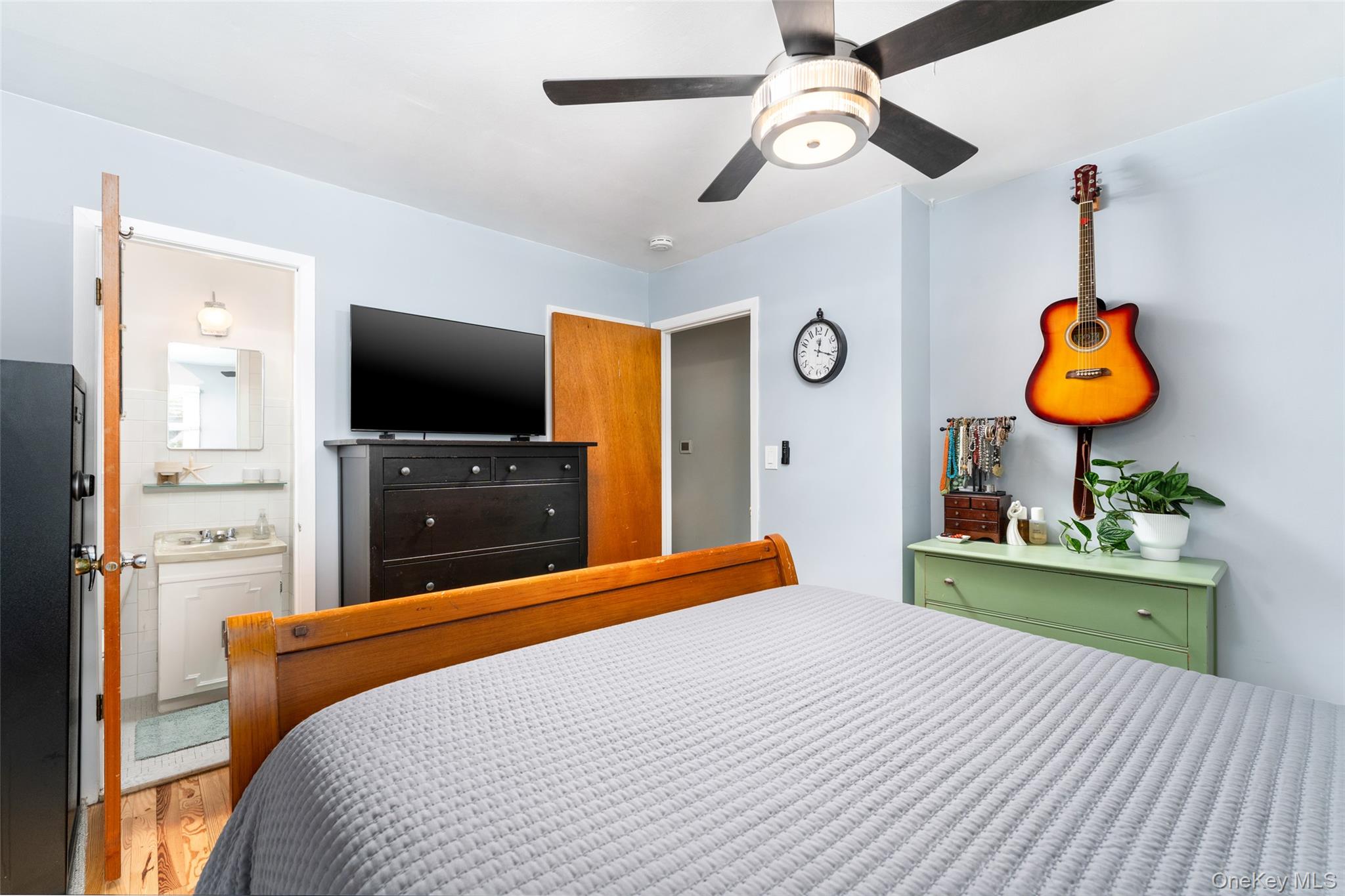 8 Foxboro Road Hampton Bays, NY 11946 - Photo 24 of 50 a bedroom with a bed and a flat tv screen on dresser
