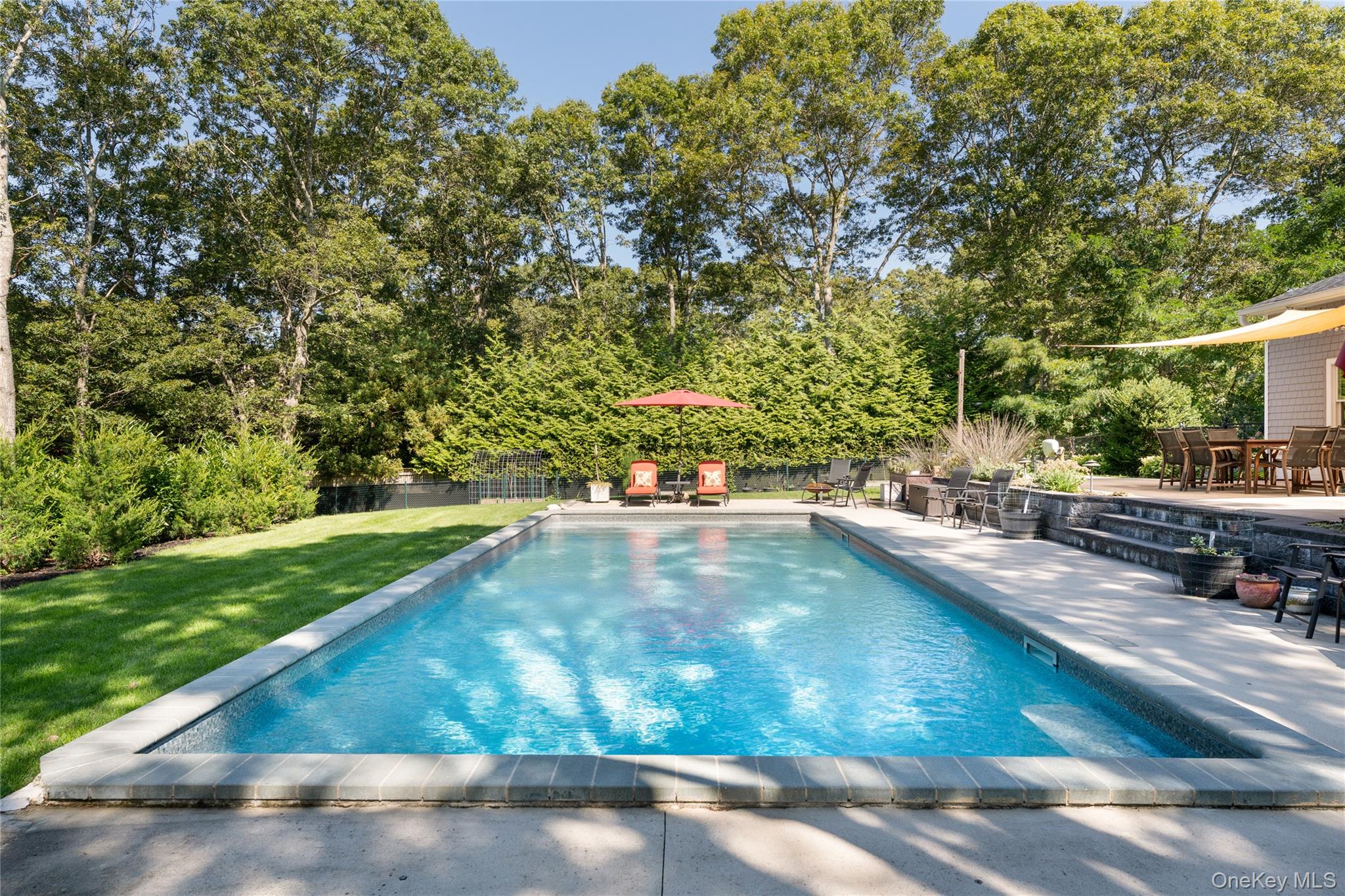8 Foxboro Road Hampton Bays, NY 11946 - Photo 29 of 50 a view of a swimming pool with a yard