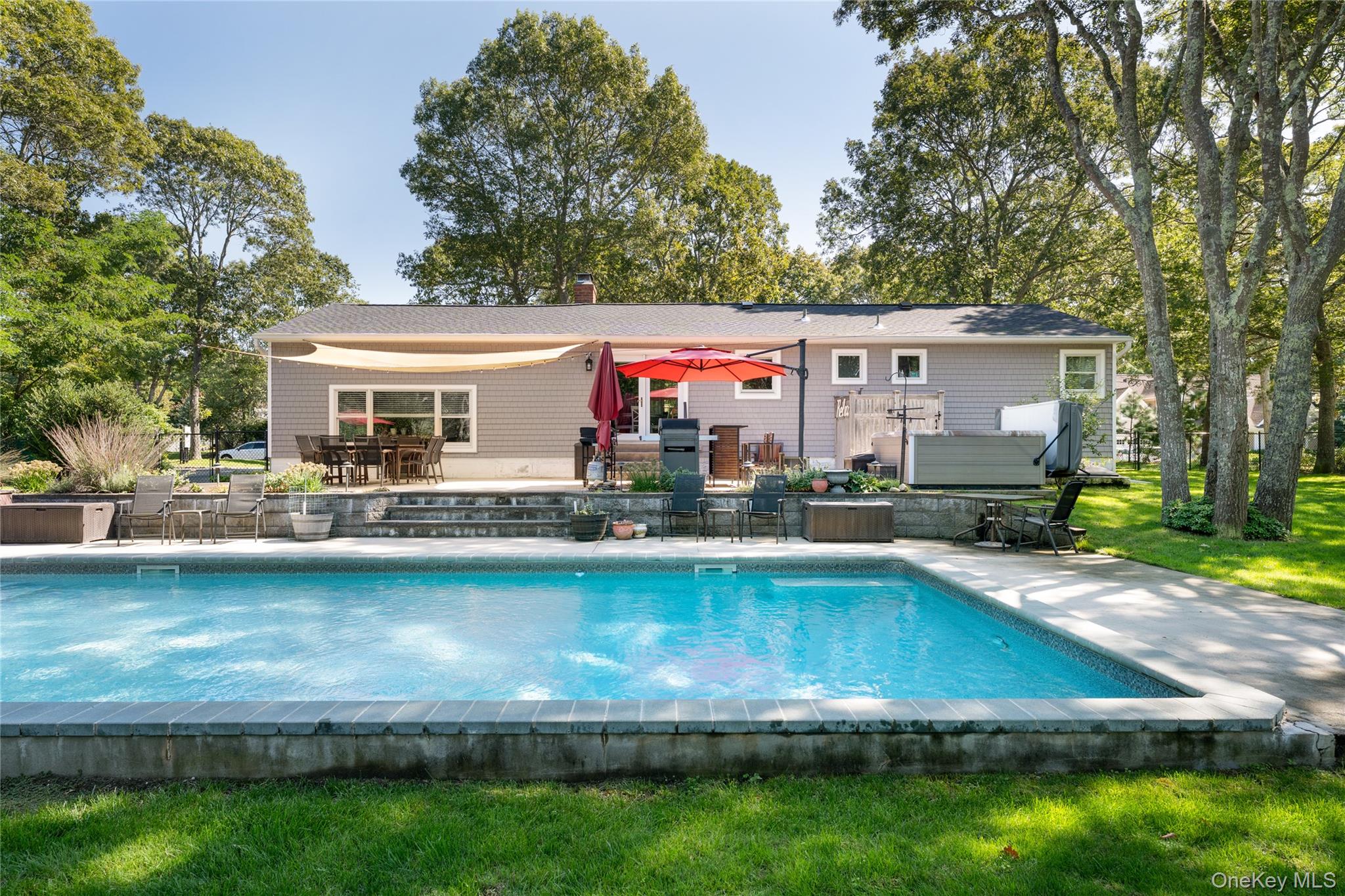 8 Foxboro Road Hampton Bays, NY 11946 - Photo 31 of 50 a view of a house with swimming pool and a yard