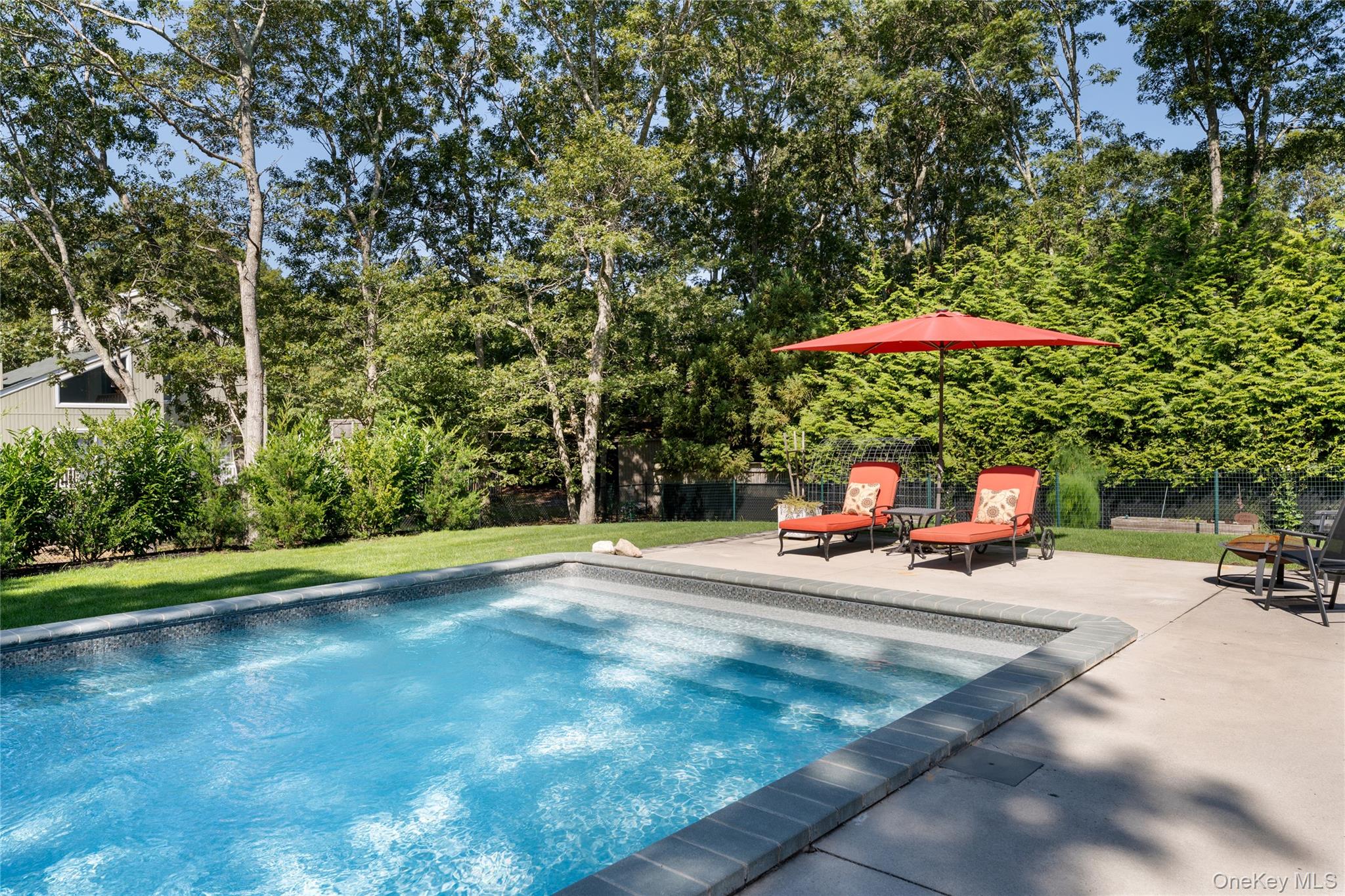 8 Foxboro Road Hampton Bays, NY 11946 - Photo 33 of 50 a view of a backyard with a patio and swimming pool