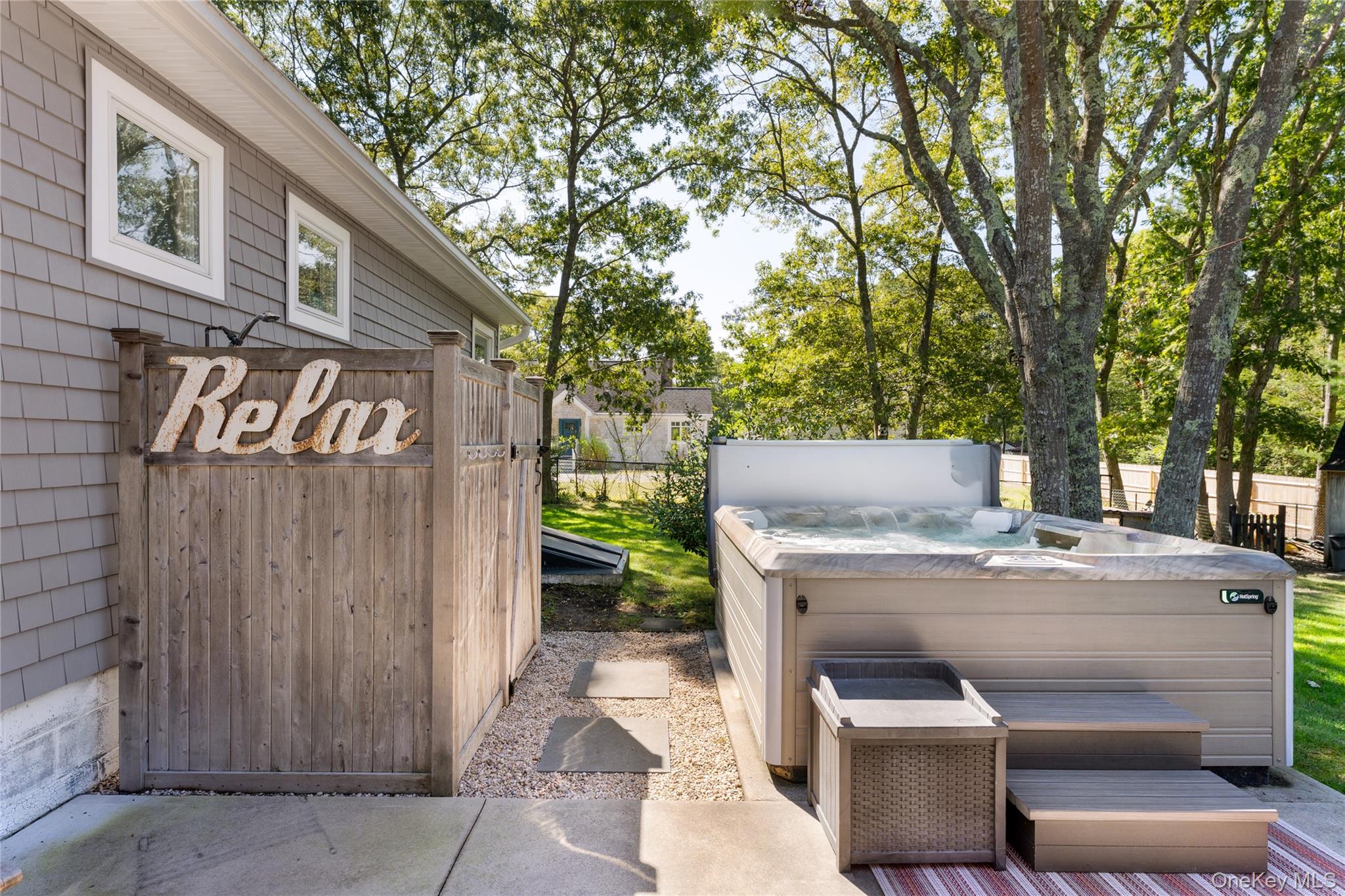 8 Foxboro Road Hampton Bays, NY 11946 - Photo 35 of 50 a view of a patio with table and chairs with barbeque grill and a small yard