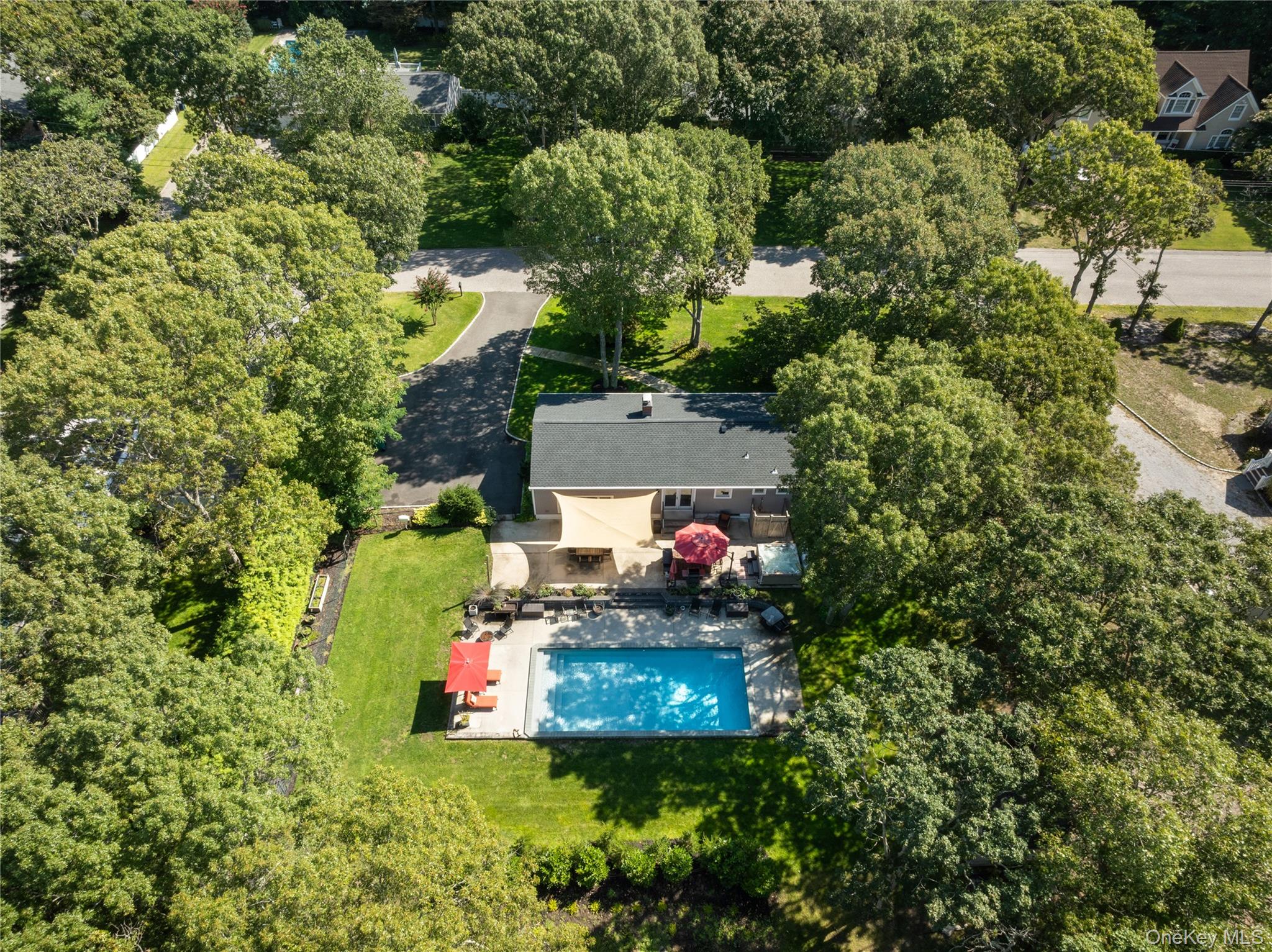 8 Foxboro Road Hampton Bays, NY 11946 - Photo 41 of 50 an aerial view of a house with swimming pool and garden