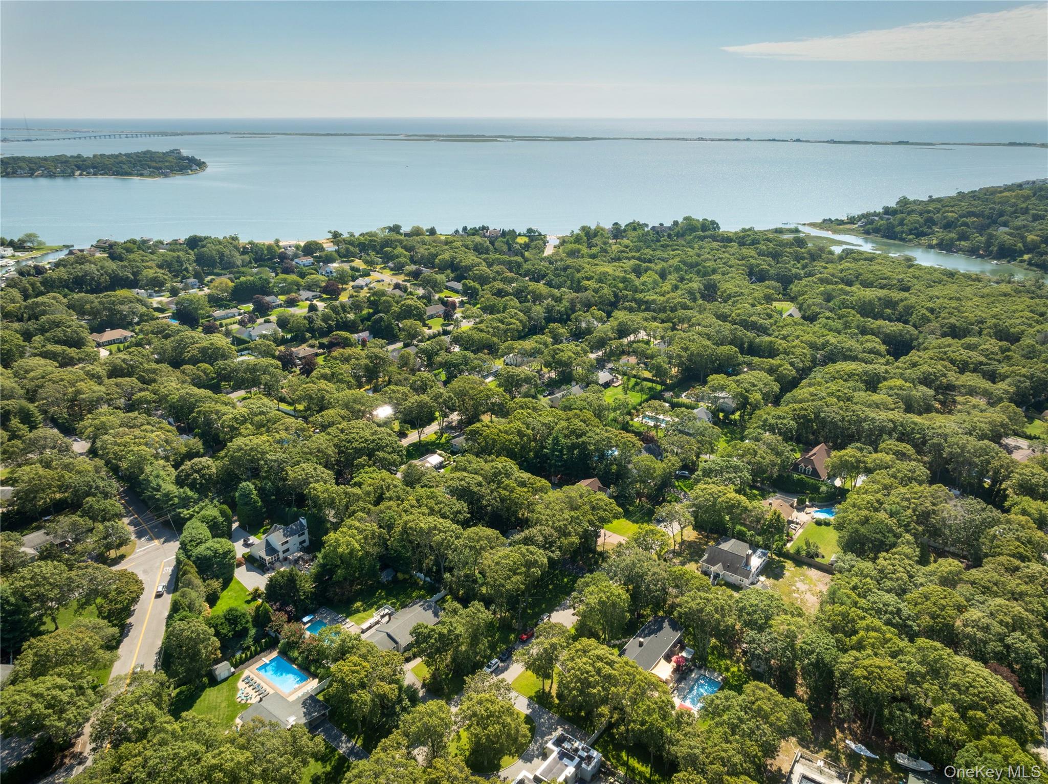 8 Foxboro Road Hampton Bays, NY 11946 - Photo 43 of 50 a view of a lake with a city