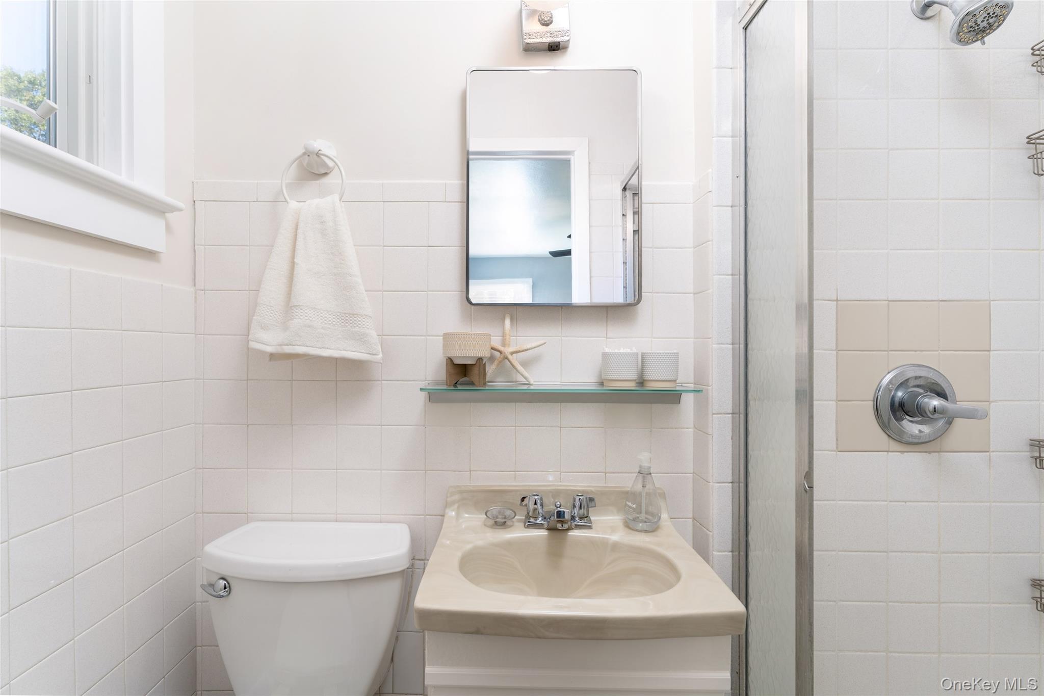 8 Foxboro Road Hampton Bays, NY 11946 - Photo 49 of 50 a bathroom with a sink a toilet and mirror