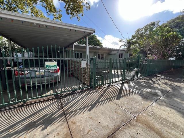 501 East 8th Street Hialeah, FL 33010 - Photo 3 of 7 a view of a patio with table and chairs under an umbrella with a small yard