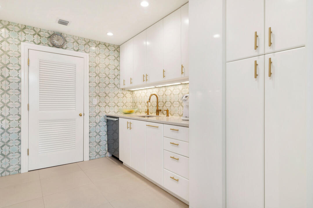 44 Cocoanut Row, Unit 320B Palm Beach, FL 33480 - Photo 5 of 27 a view of kitchen and white cabinets
