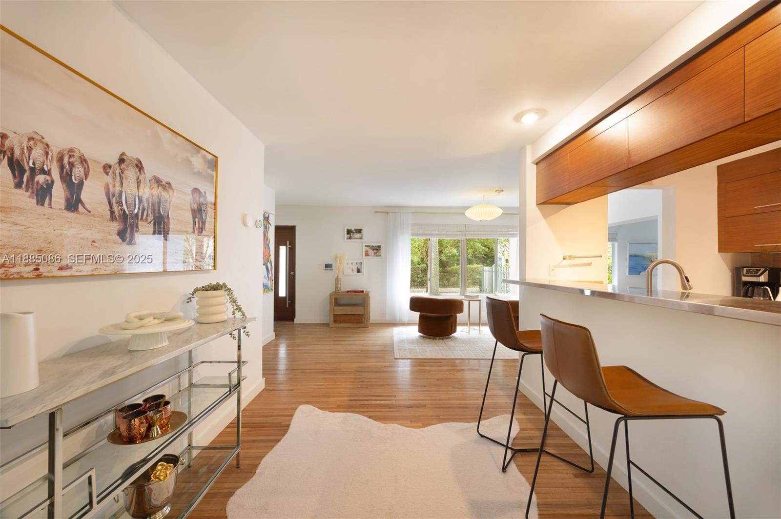 3894 Main Highway Miami, FL 33133 - Photo 11 of 24 a living room with furniture a large window with kitchen view