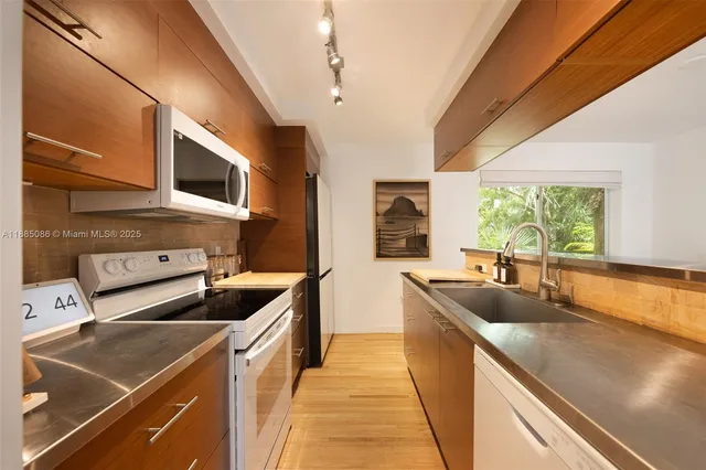 a kitchen that has a sink and a stove