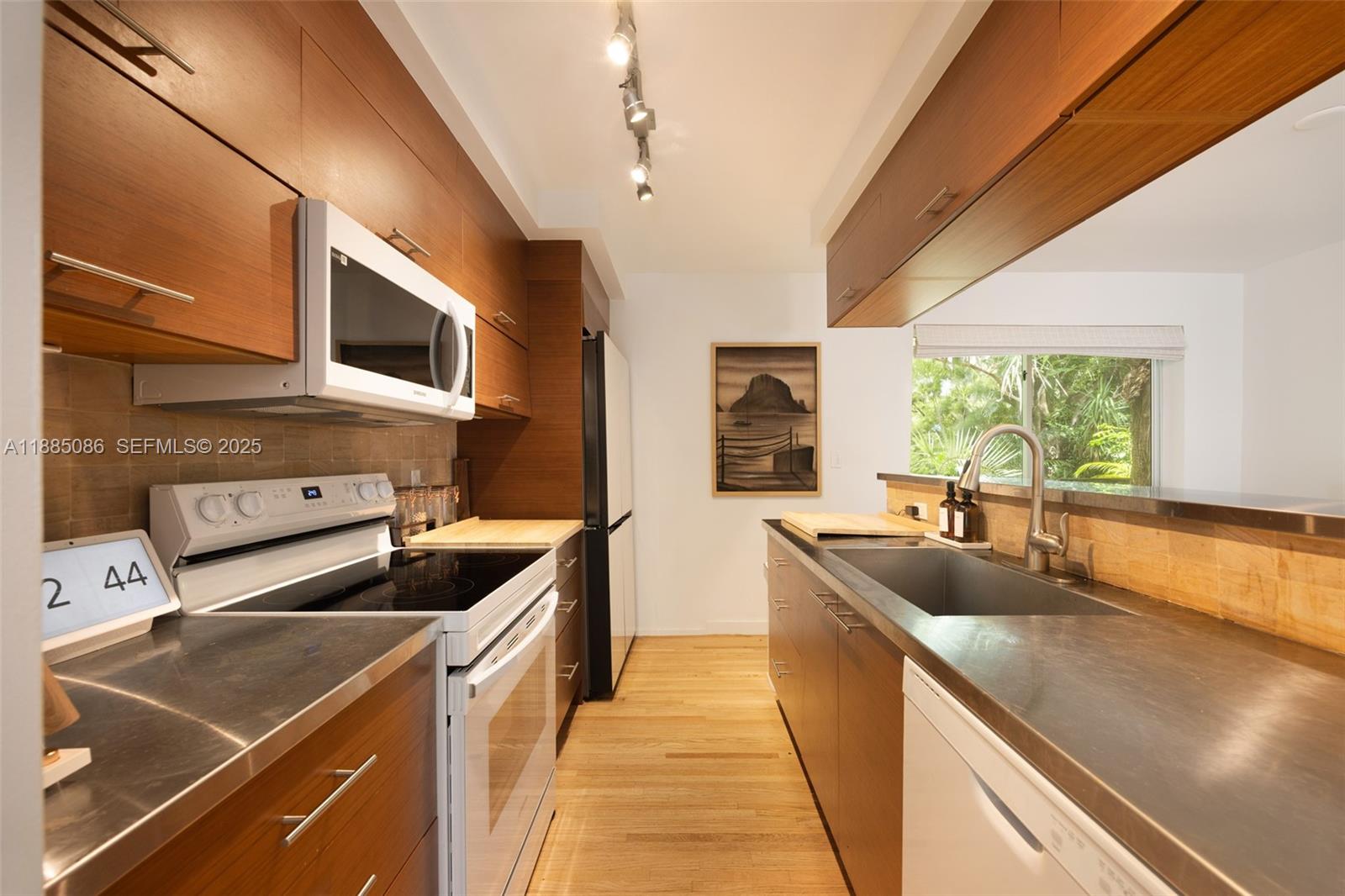 3894 Main Highway Miami, FL 33133 - Photo 13 of 24 a kitchen that has a sink and a stove