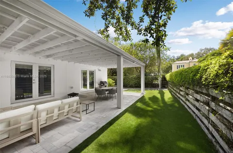 a view of a house with backyard sitting area and garden