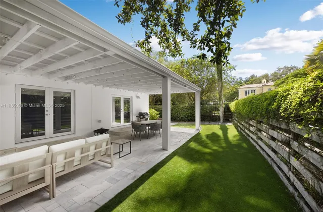 a view of a house with backyard sitting area and garden