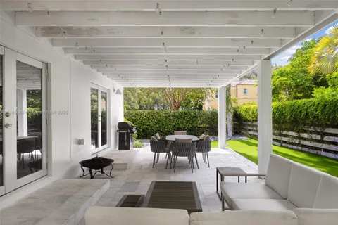 a view of a patio with a dining table and chairs