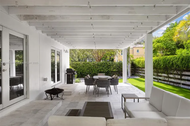 a view of a patio with a dining table and chairs