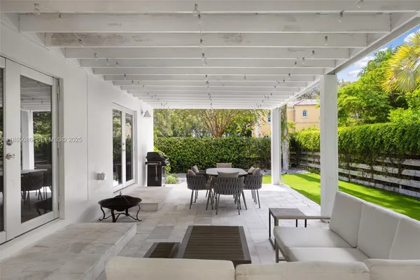 a view of a patio with a dining table and chairs