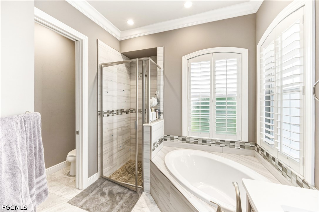 1700 43rd Terrace Southwest Naples, FL 34116 - Photo 28 of 38 a spacious bathroom with a tub shower and a sink