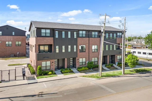 a view of a brick building next to a yard