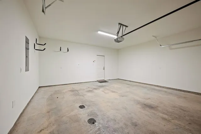 an empty room with fan and windows
