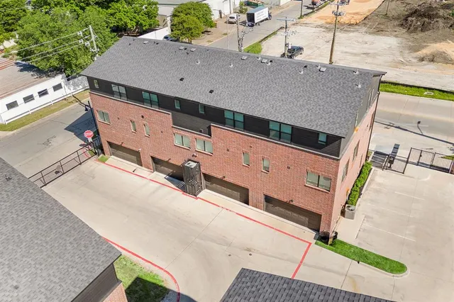 an aerial view of a house with a street