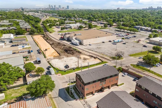 an aerial view of a house with a swimming pool and mountains