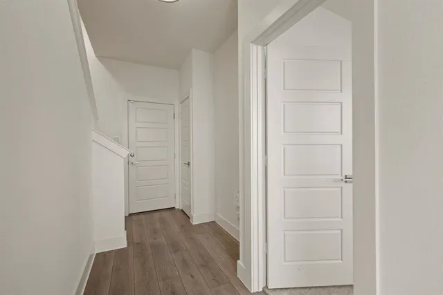 an empty room with wooden floor and closet