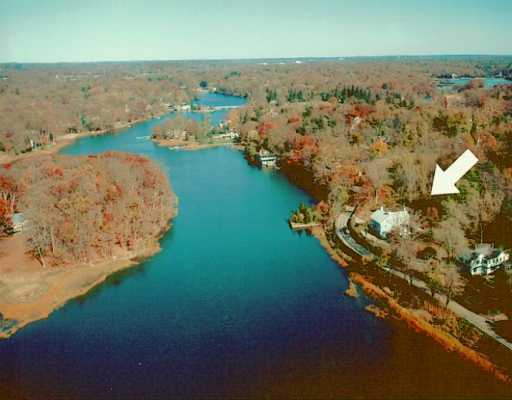an aerial view of beach and residential houses with outdoor space