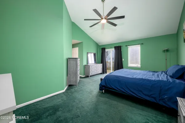 a spacious bedroom with a bed and a window