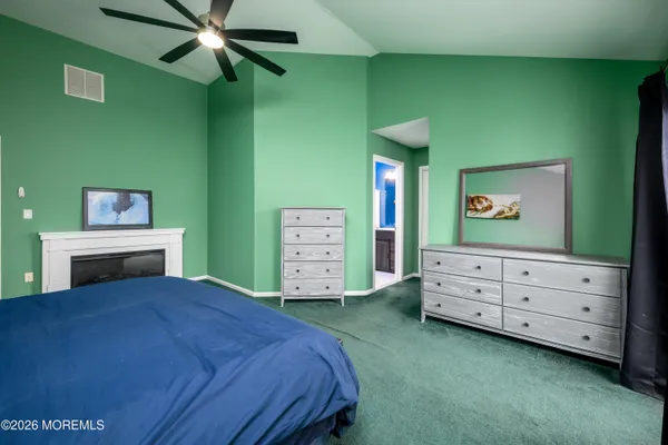 a bedroom with a bed and a dresser