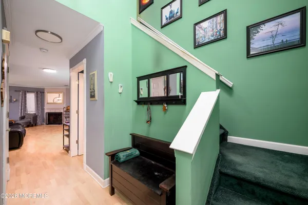 a view of a hallway with furniture and stairs