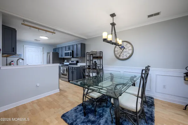 a view of a dining room with furniture wooden floor and a clock