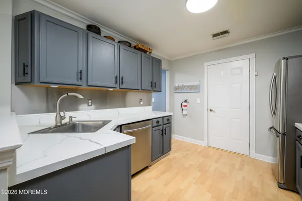 a kitchen with a sink stove and refrigerator