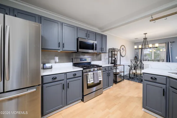 a kitchen with a sink stove and refrigerator