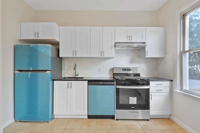 a kitchen with cabinets and stainless steel appliances