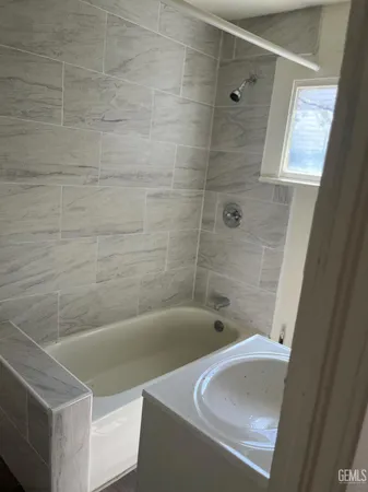 a bathroom with a tub and a shower
