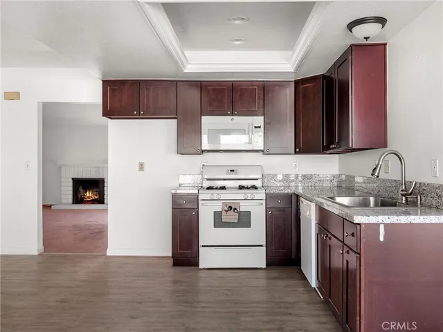 a kitchen with stainless steel appliances granite countertop a stove sink and cabinets