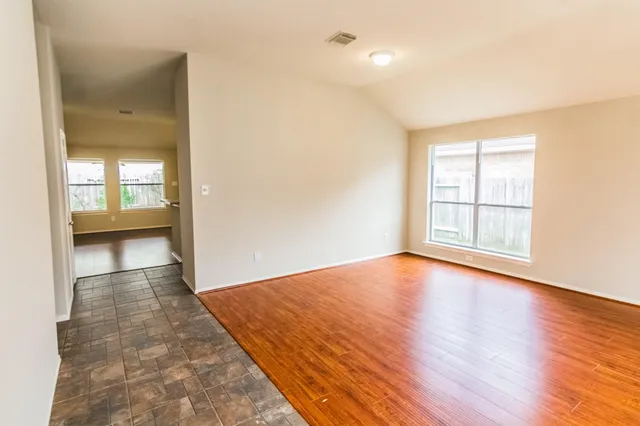 wooden floor in an empty room with a window