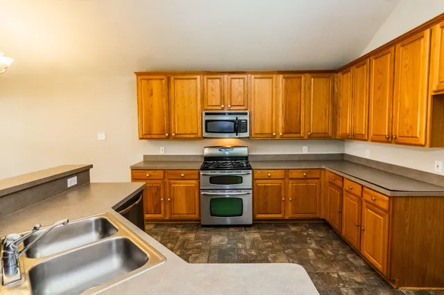 a kitchen with a stove a sink and a microwave