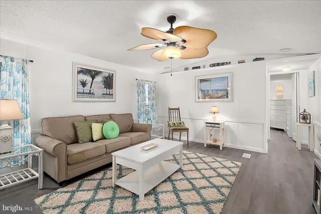 a living room with furniture a chandelier and a window
