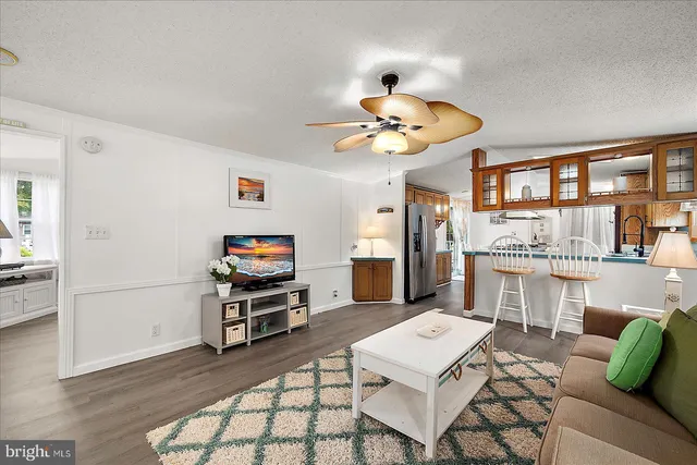 a living room with furniture and kitchen view