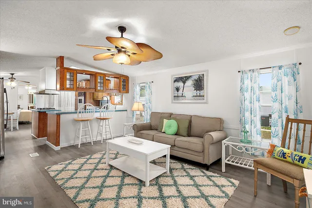a living room with furniture a rug and white walls