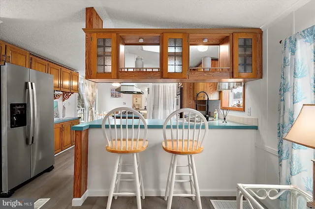 a living room with furniture a fireplace and a chandelier