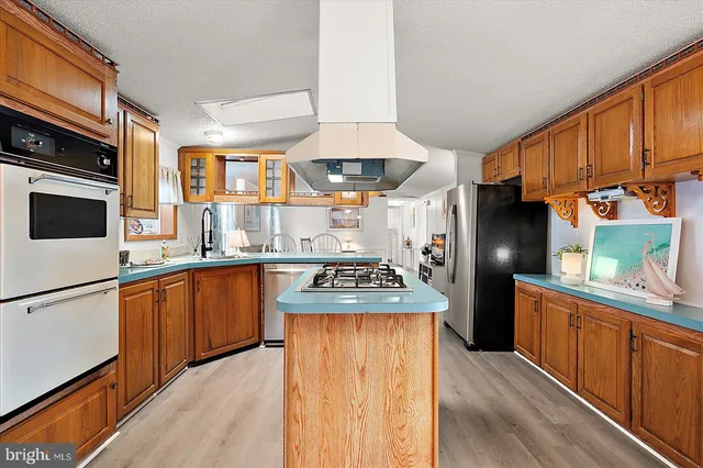 a kitchen with stainless steel appliances granite countertop a stove and a refrigerator