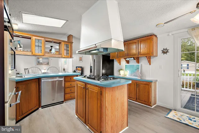 a kitchen with stainless steel appliances a sink stove and cabinets