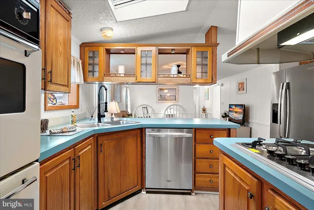 a kitchen with stainless steel appliances a sink stove and cabinets