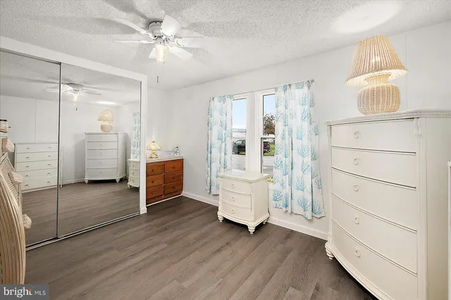 a living room with stainless steel appliances kitchen island granite countertop furniture and a chandelier
