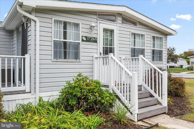 a view of a house with deck and garden