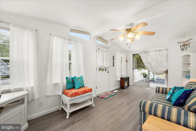 a living room with furniture fireplace and a window