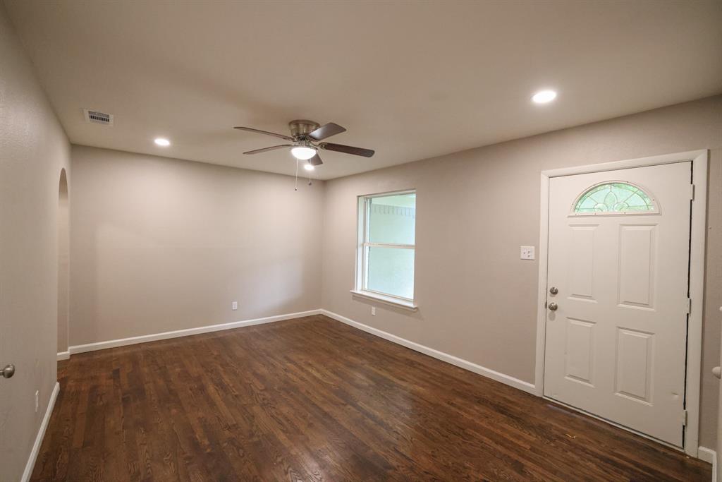427 Daniel Street Richardson, TX 75080 - Photo 3 of 8 wooden floor in an empty room with a window
