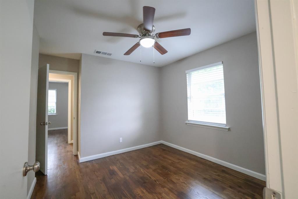 427 Daniel Street Richardson, TX 75080 - Photo 6 of 8 an empty room with wooden floor fan and windows